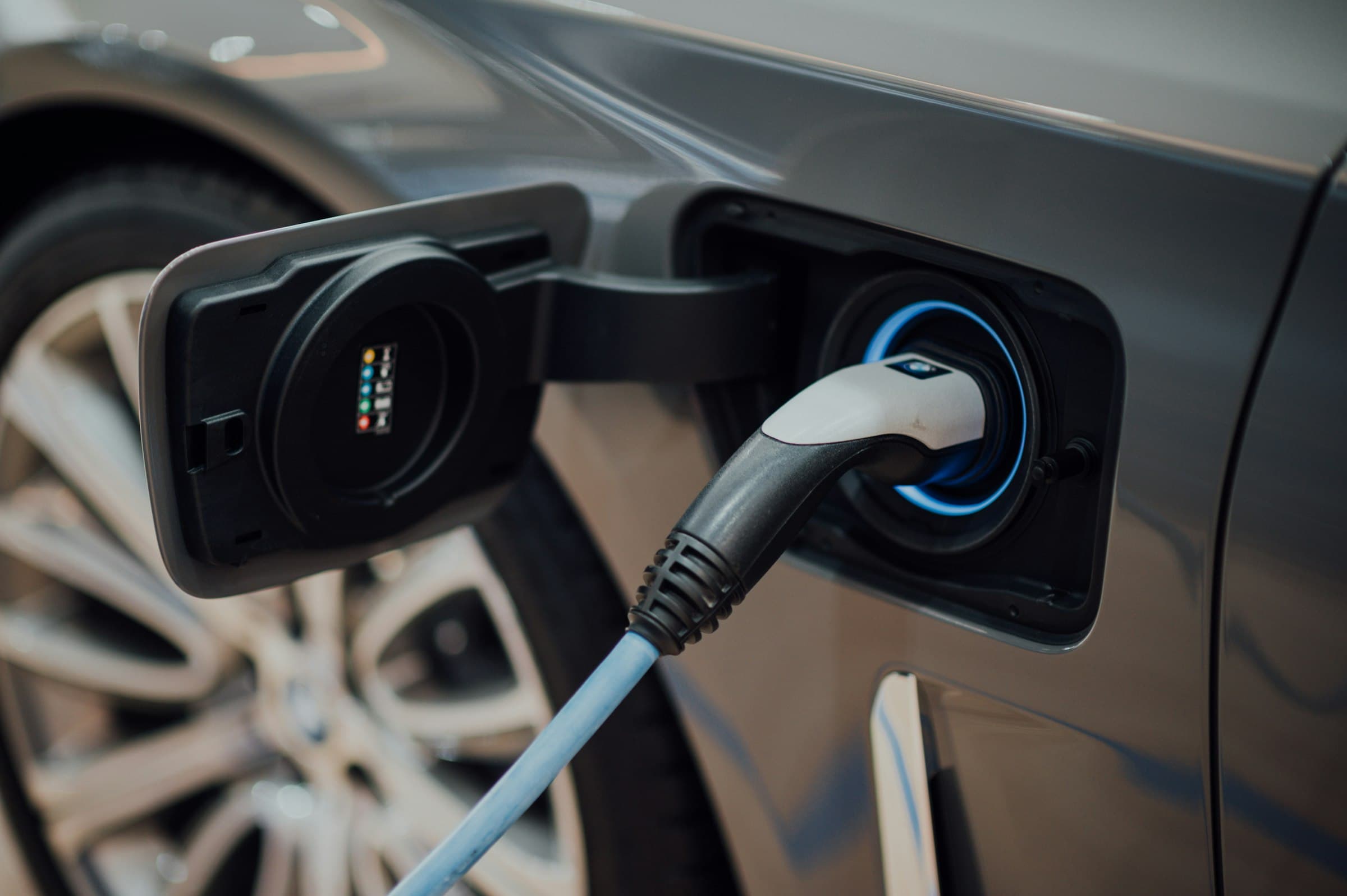 An electric vehicle charging cable plugged into a car