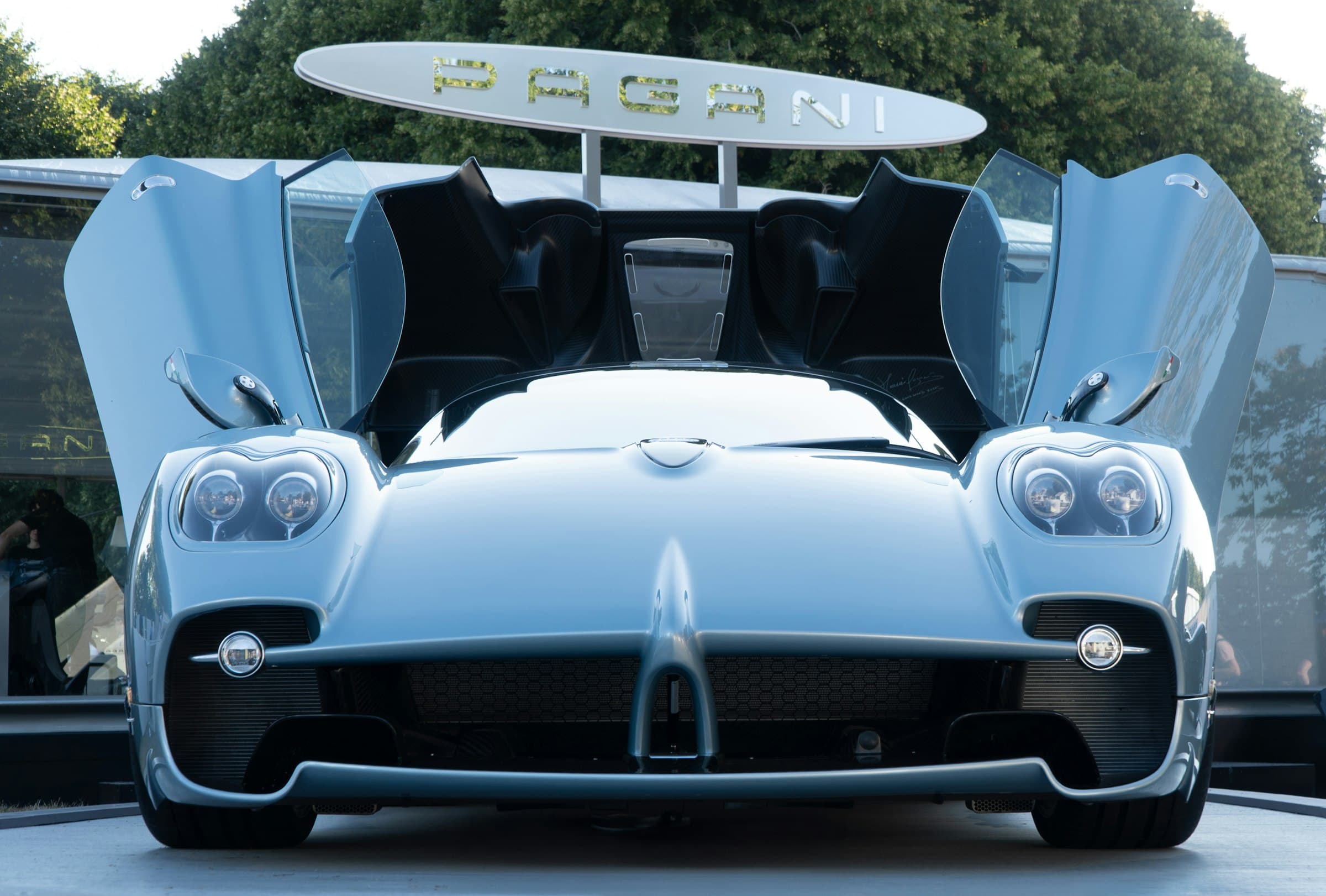 A blue supercar with doors open